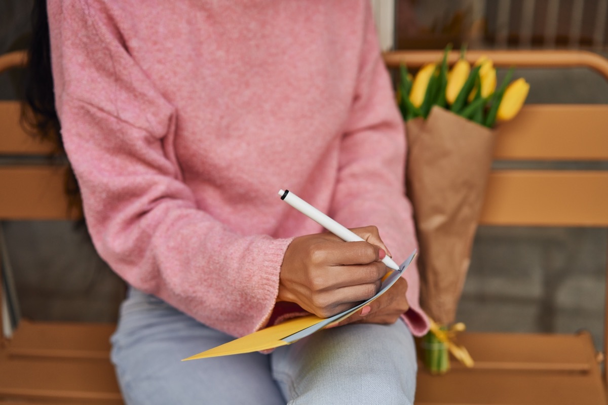 woman writing a romantic love letter for him