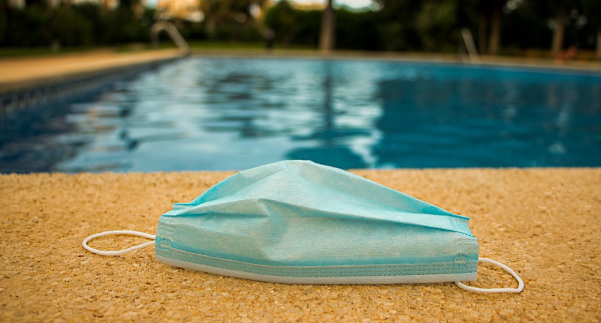 Medical mask on the blue pool background