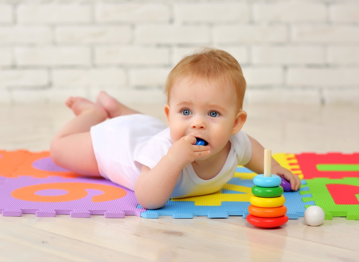 A child with a toy in their mouth