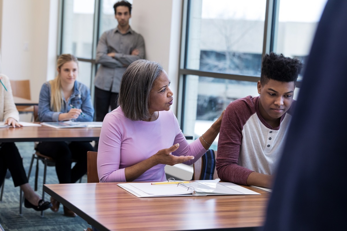 worried mother talking to her child at the parent teacher conference