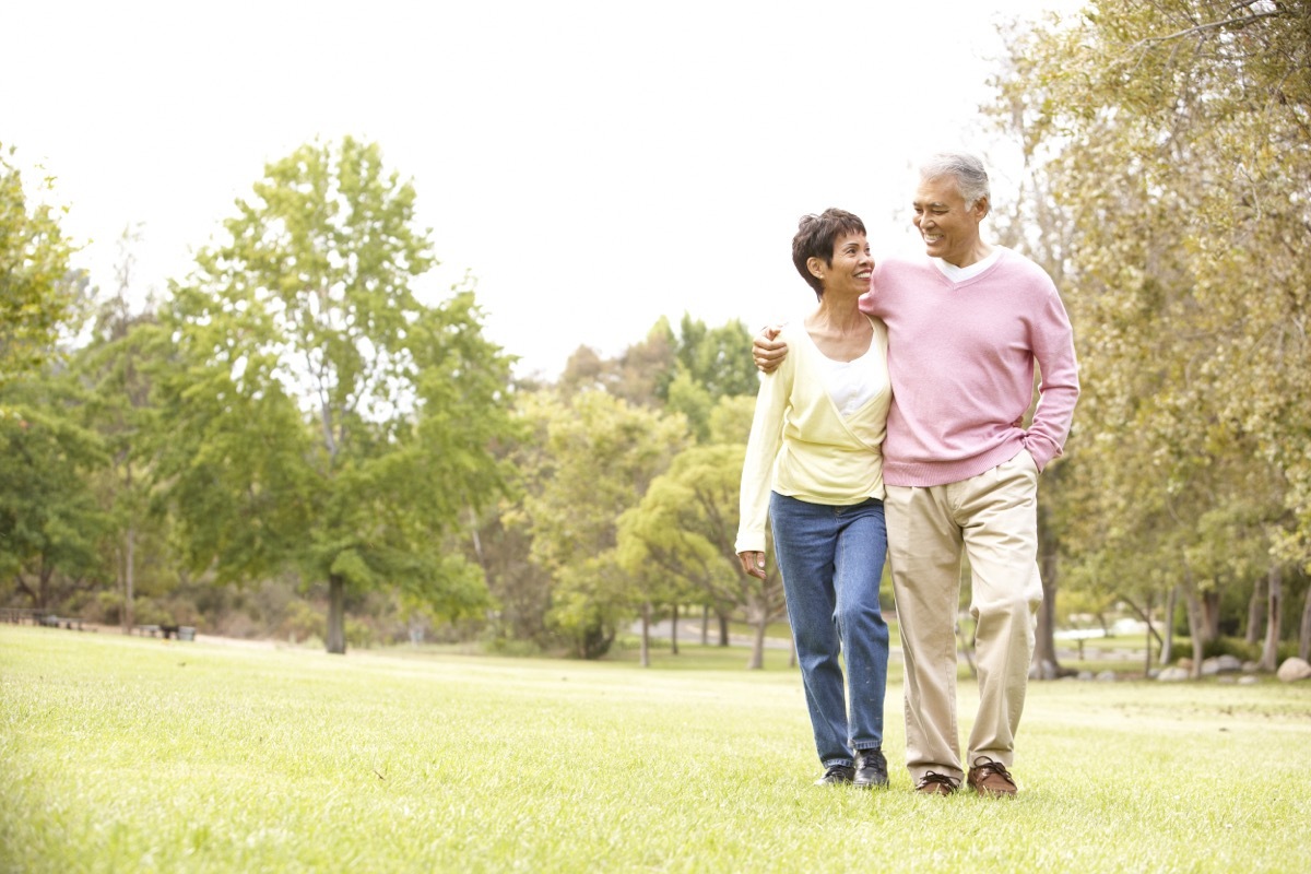 senior couple walking in park