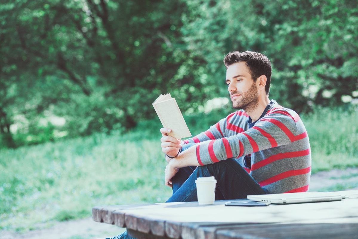 Man reading a book in the park