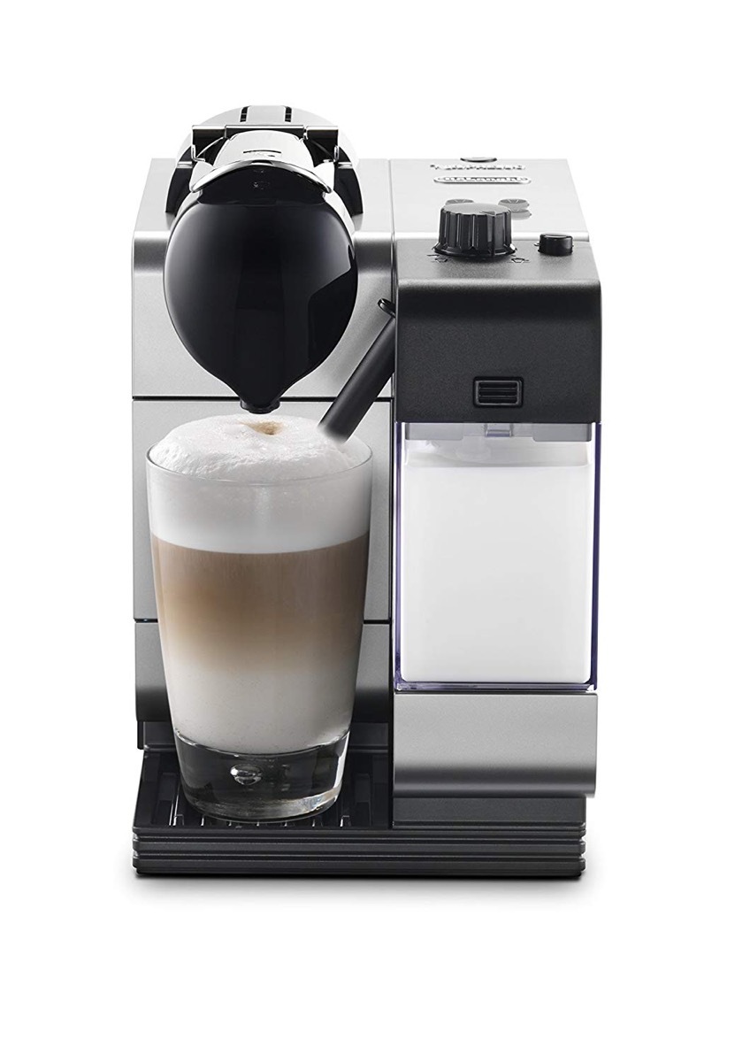 black espresso and cappuccino machine with clear mug of cappuccino on white background