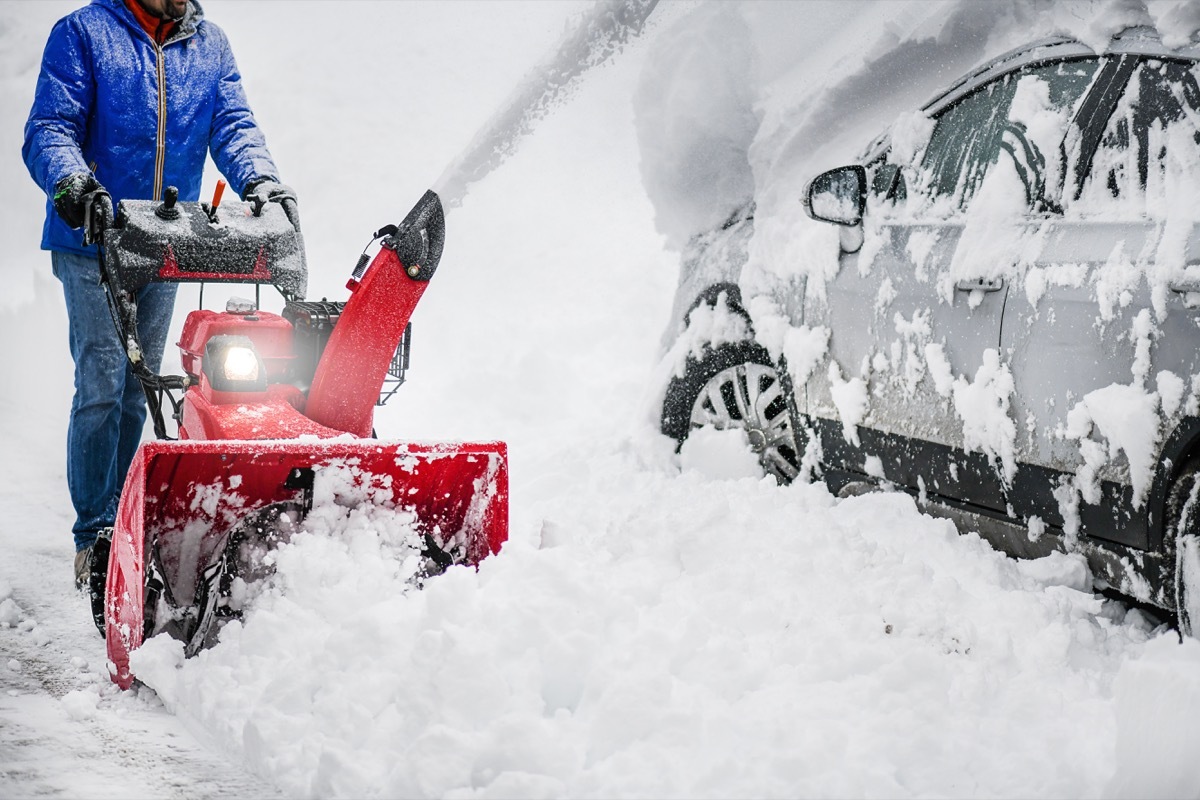 Person Using a Snowblower in the Winter