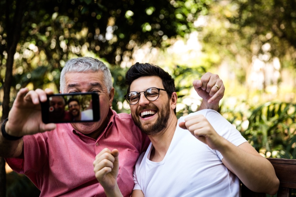 father and son taking selfie