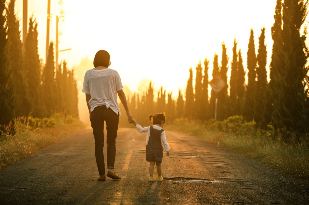 mother daughter walking trees