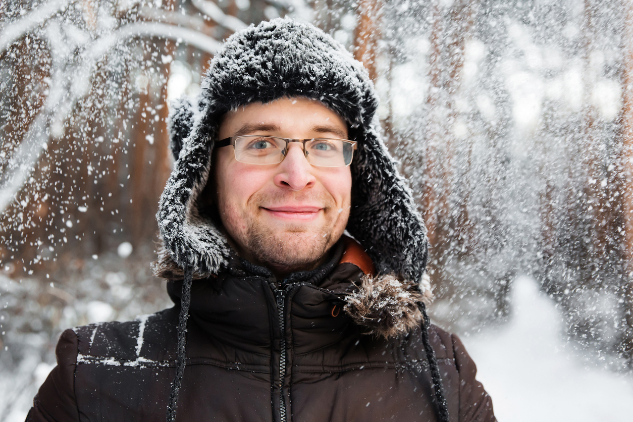 young man in trapper hat in nature