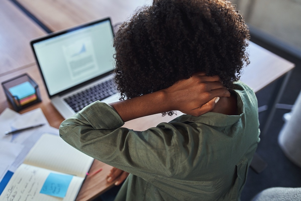 Woman with headache at base of head 