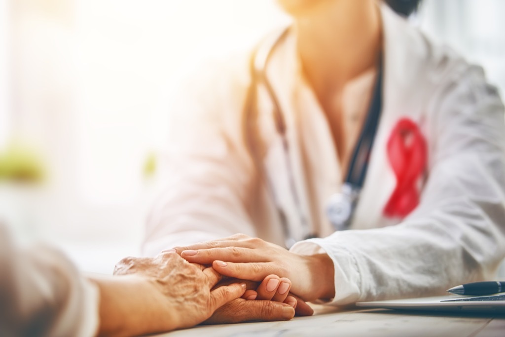 breast cancer doctor holding patients hand