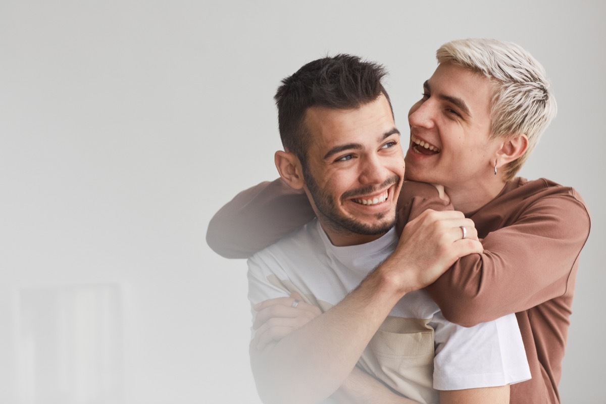 two men laughing and embracing