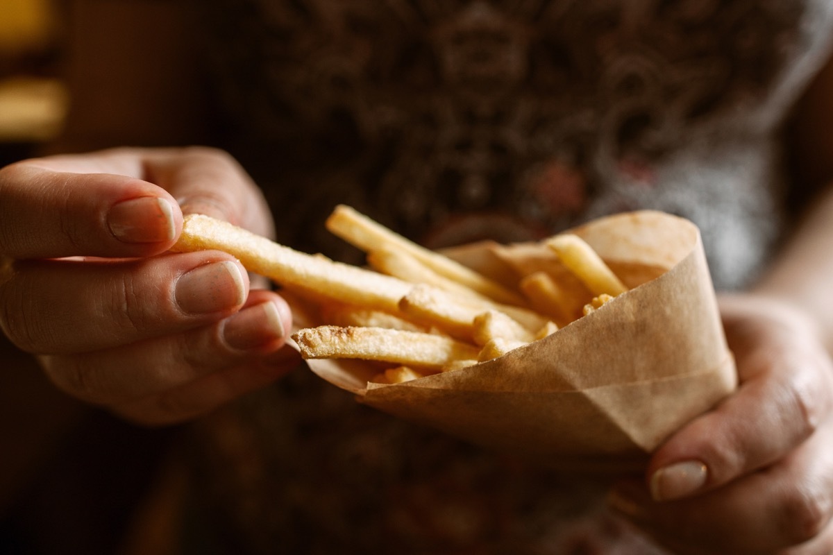 Person eating some salty french fries