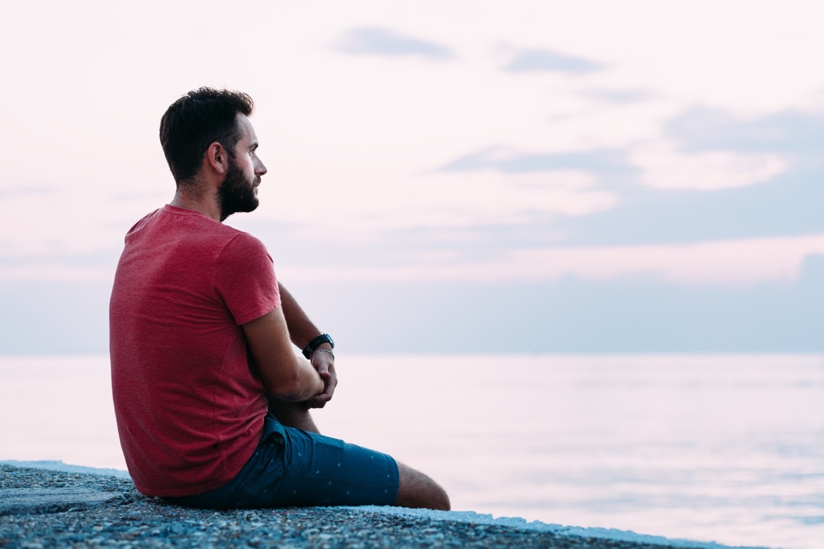 young white man looking out at the water