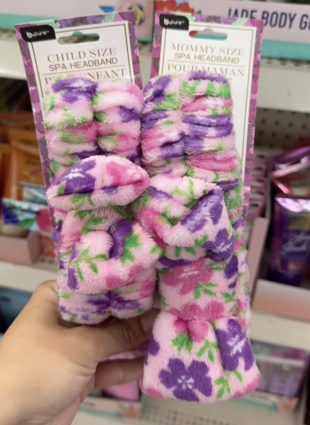 A shopper holds a shower headband set in Dollar Tree while shopping for the best Mother's Day gifts.