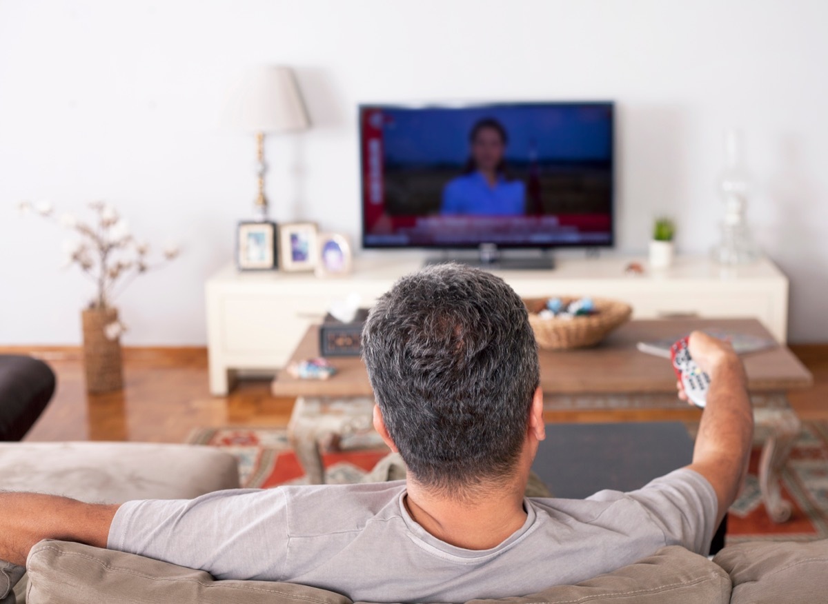 Man watching TV on couch