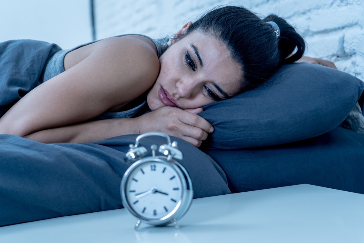 Woman awake looking at clock