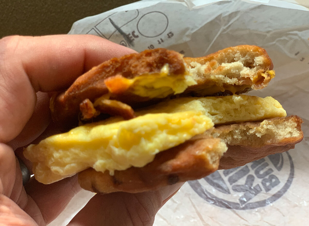 burger king waffle sandwich in hand