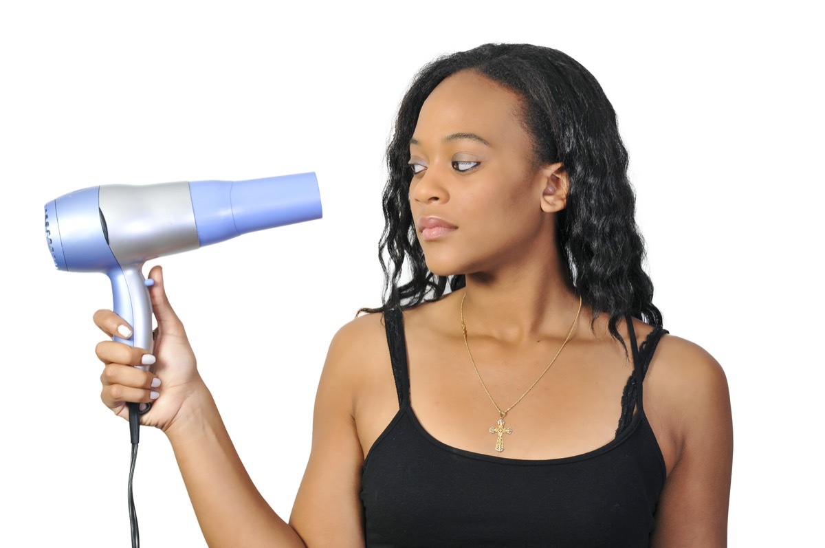 woman drying her hair