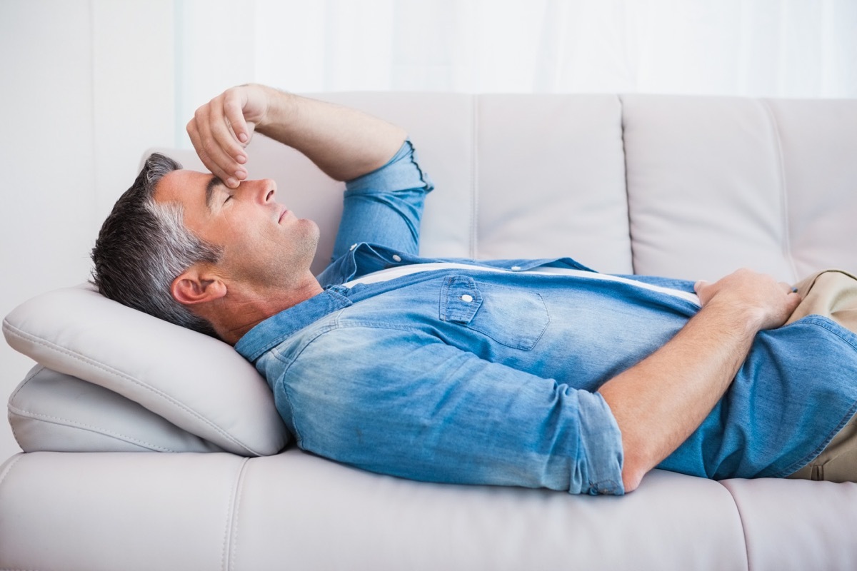 older man sleeping on couch