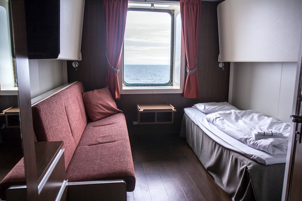 tiny cruise cabin with a single bed and couch