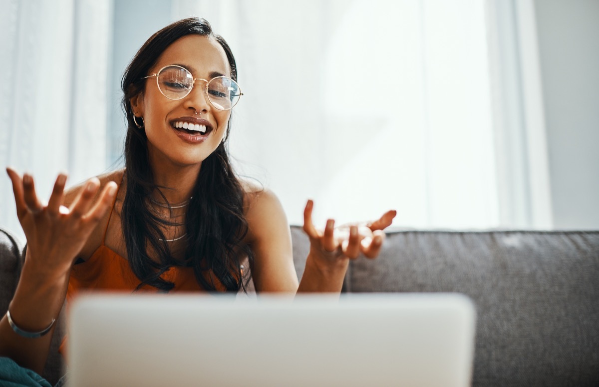 Shot of a young woman using a laptop on the sofa at home