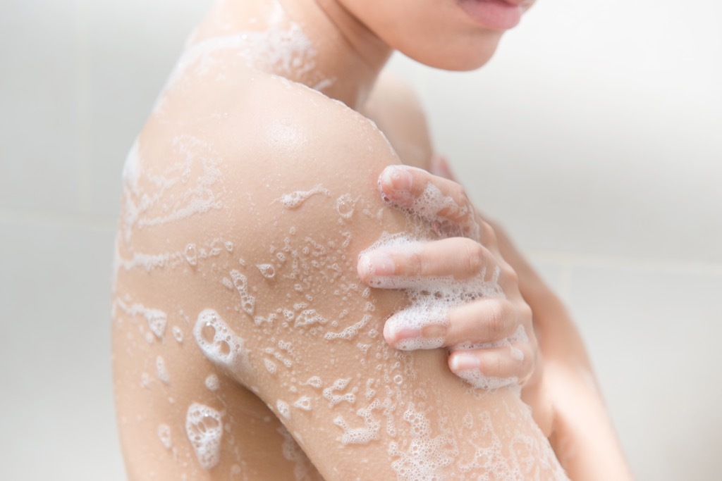 Woman using soap in the shower.