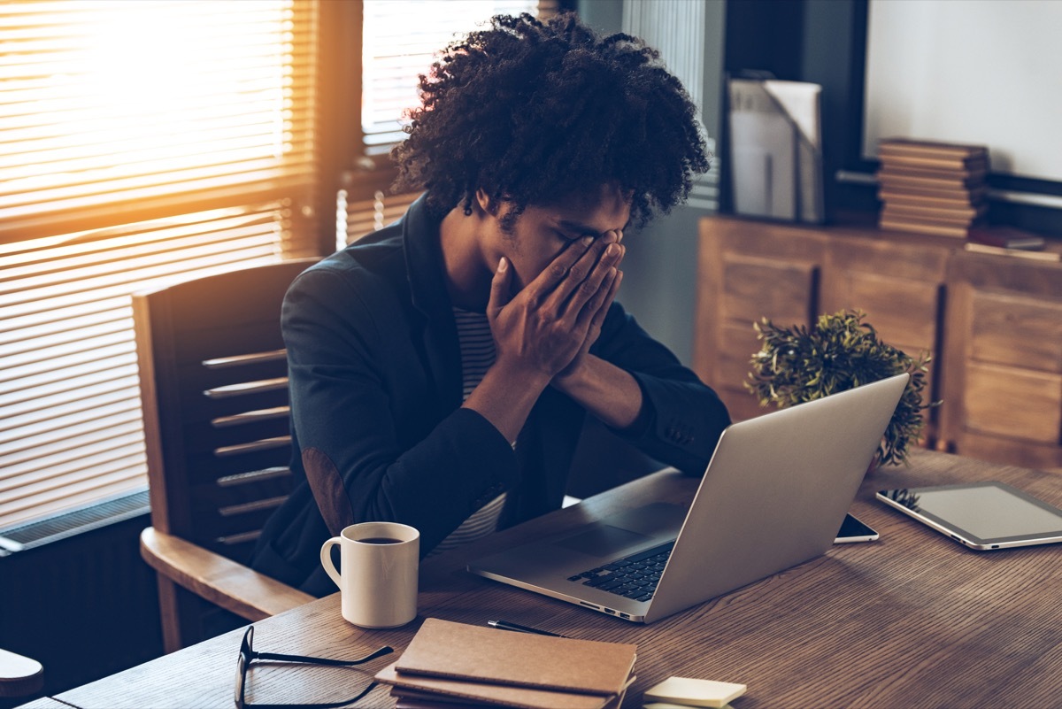 Woman at her desk looking stressed out