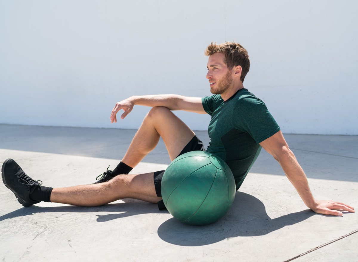 man exercising medicine ball