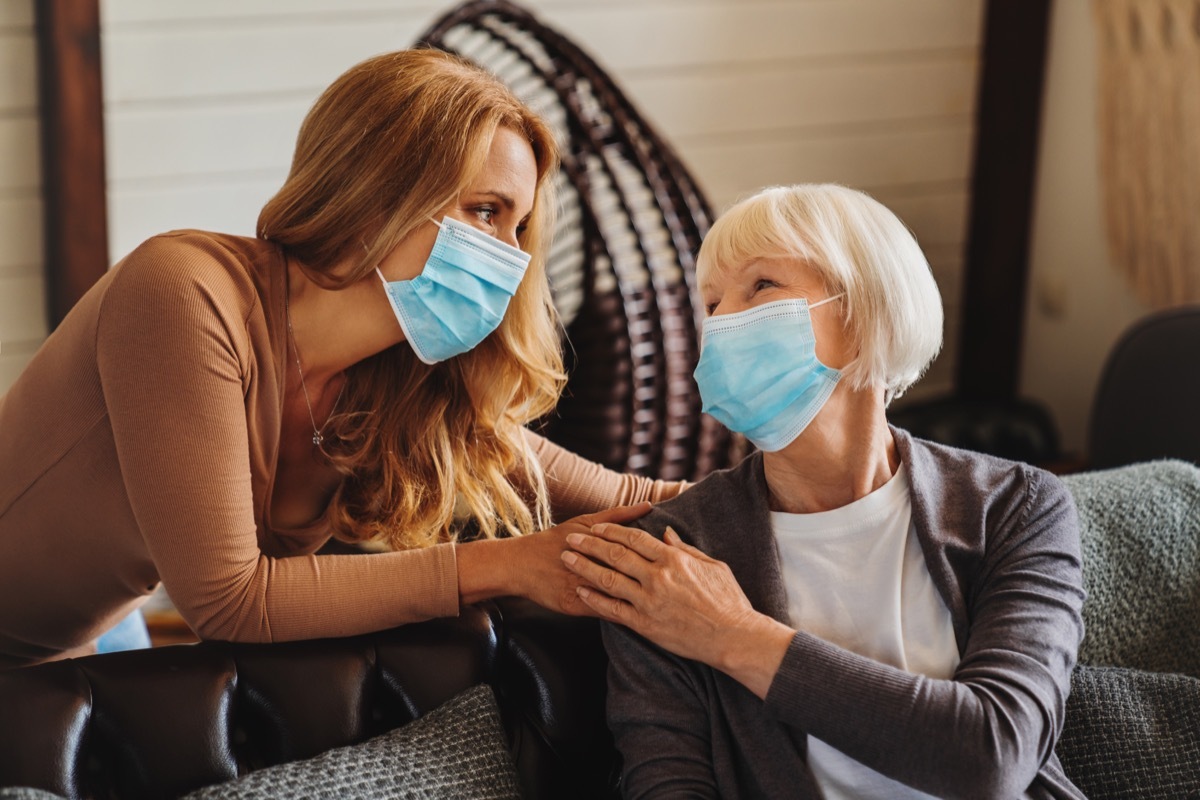 Woman and grandma wearing masks inside home