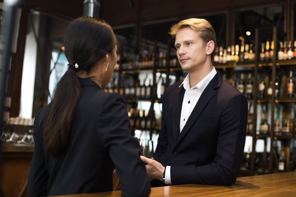 Woman Talking with Boss at Bar