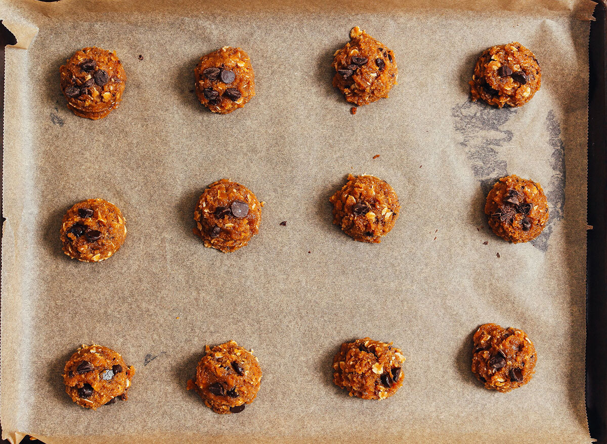 peanut butter chocolate chip cookie dough on baking sheet with parchment paper