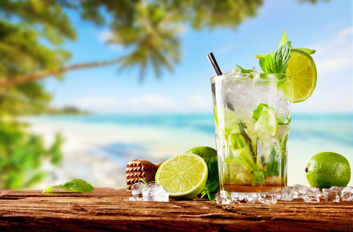 mojito in glass on wooden plank near beach