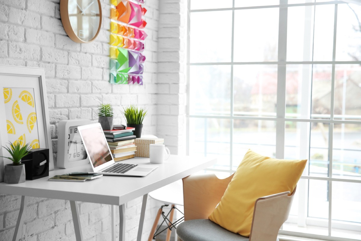 modern office with yellow pillow on white chair