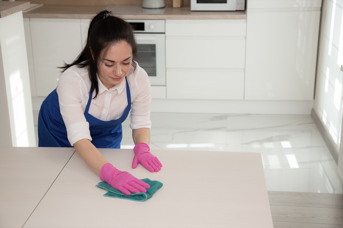 Woman cleaning with soap and water on a towel