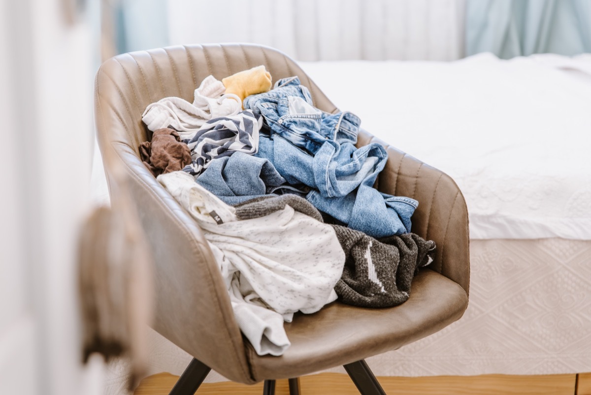 pile of dirty laundry on a chair