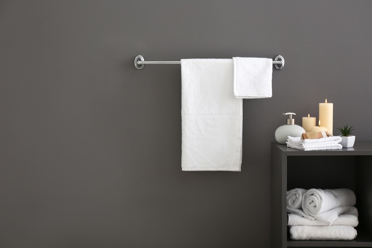 Towels hanging on a rack in the bathroom. 