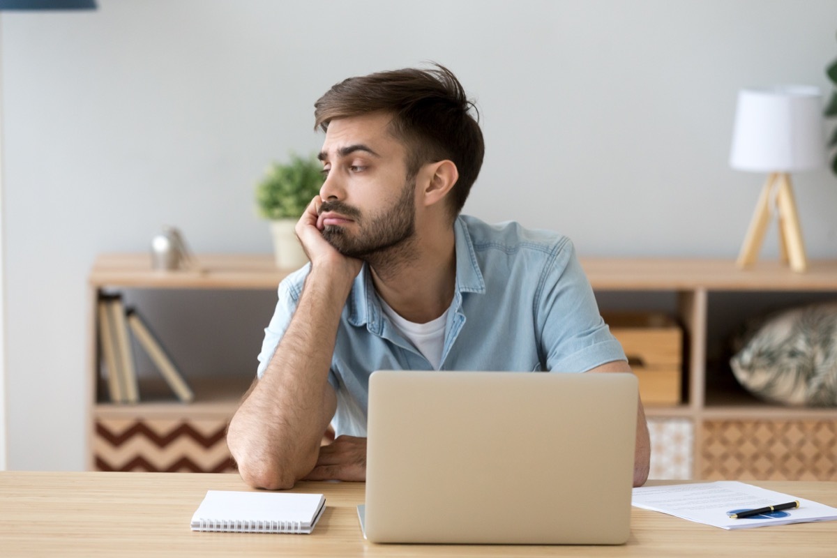 Man looking around distracted at work