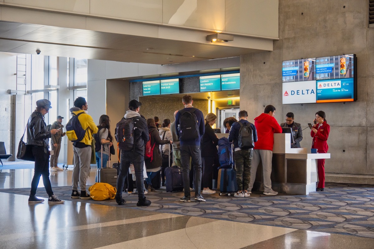 Los Angeles, United States - February 23 2020 : passengers are standing in line waiting at a boarding gate counter at an airport