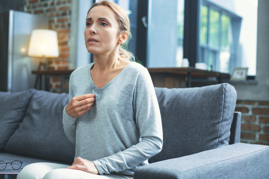 woman going through menopause having a hot flash