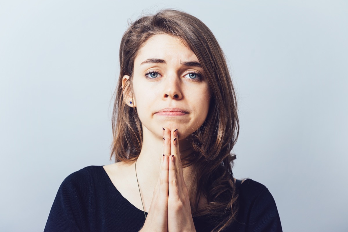 young woman asking for forgiveness