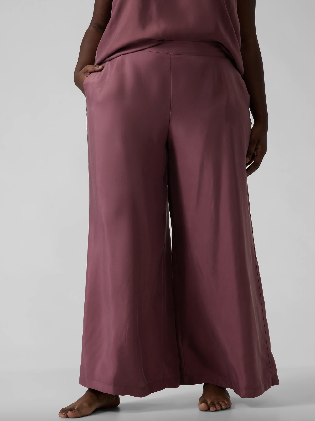 Close up product shot of model wearing Athleta's Calm Cool pajamas in dark red