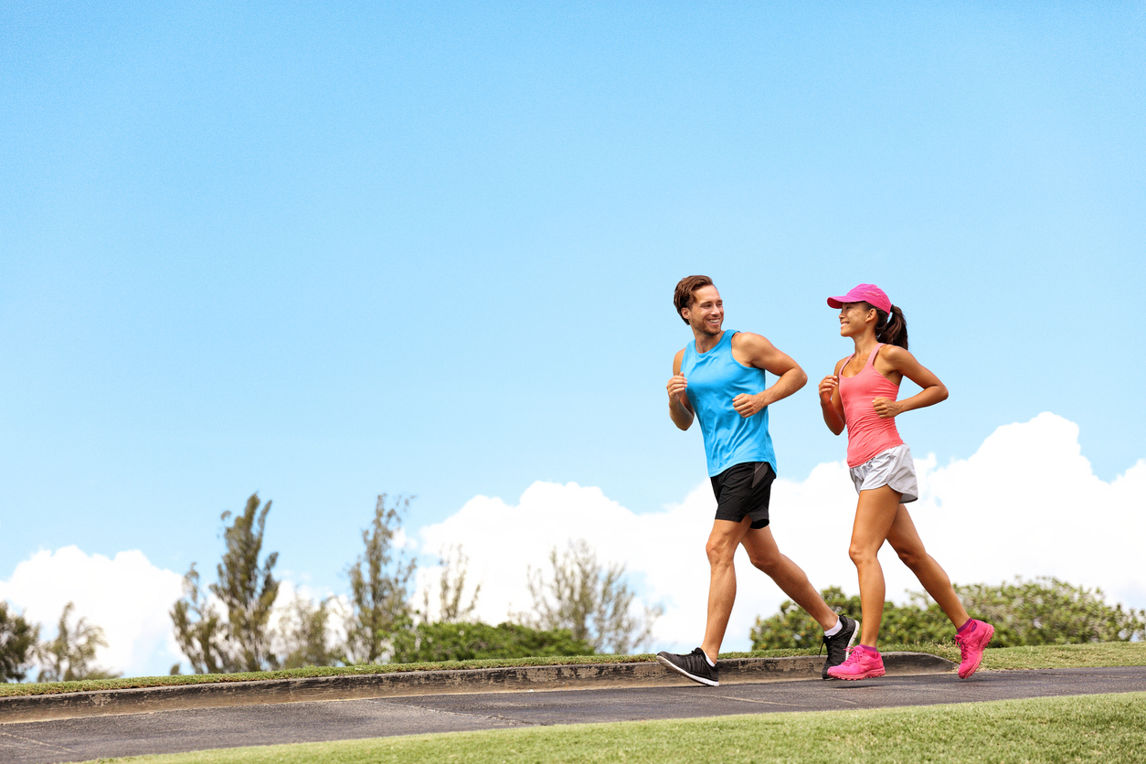 Two people jogging outside.