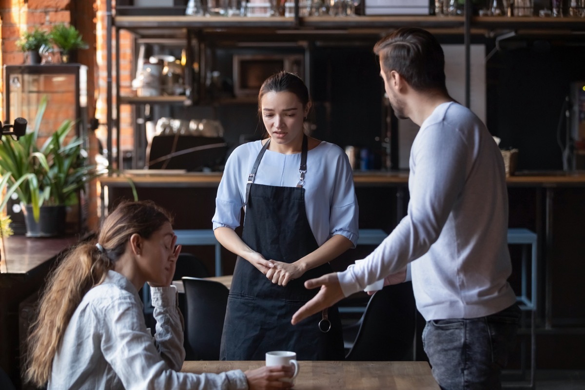 man yelling at waitress on date while upset woman looks on