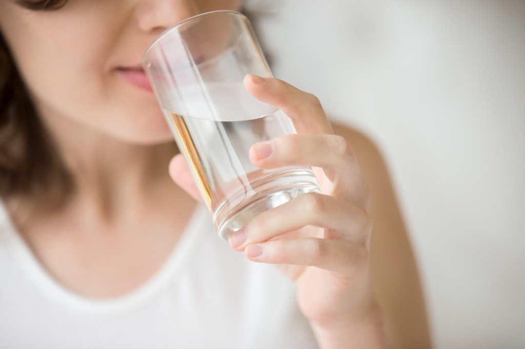 woman drinking water habits that increase your risk of a stroke