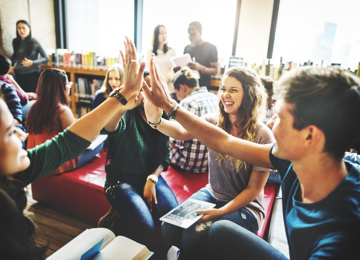 Students giving high fives during a group project