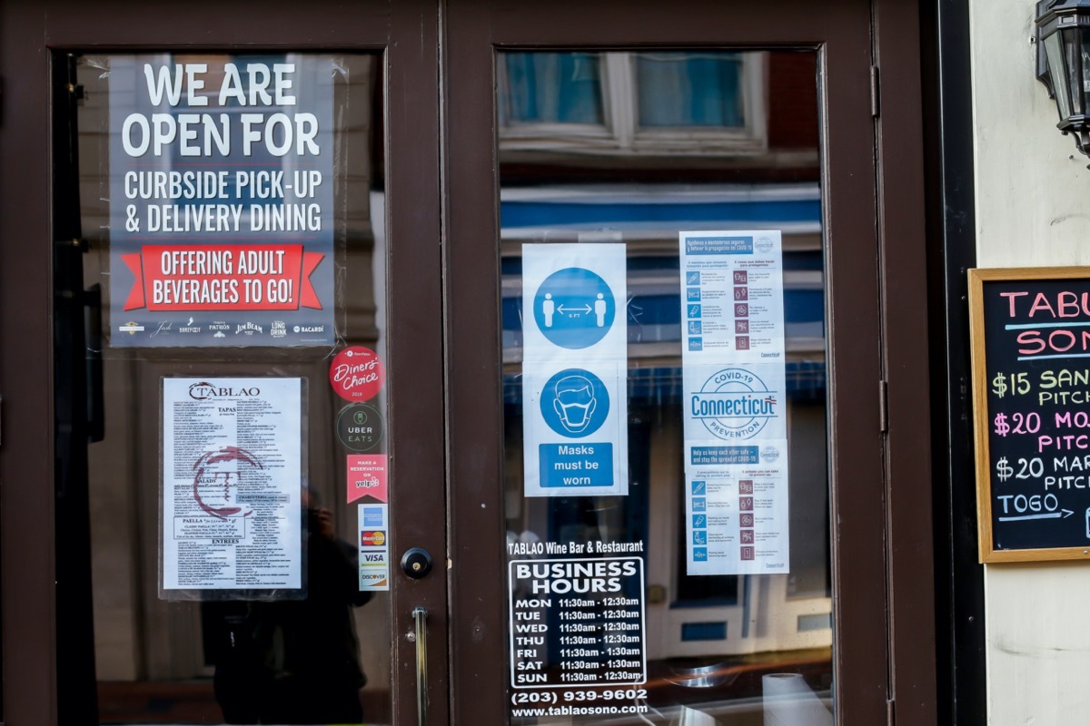 Information signs on front door Tablo wine and bar restaurant during COVID-19 Pandemic.