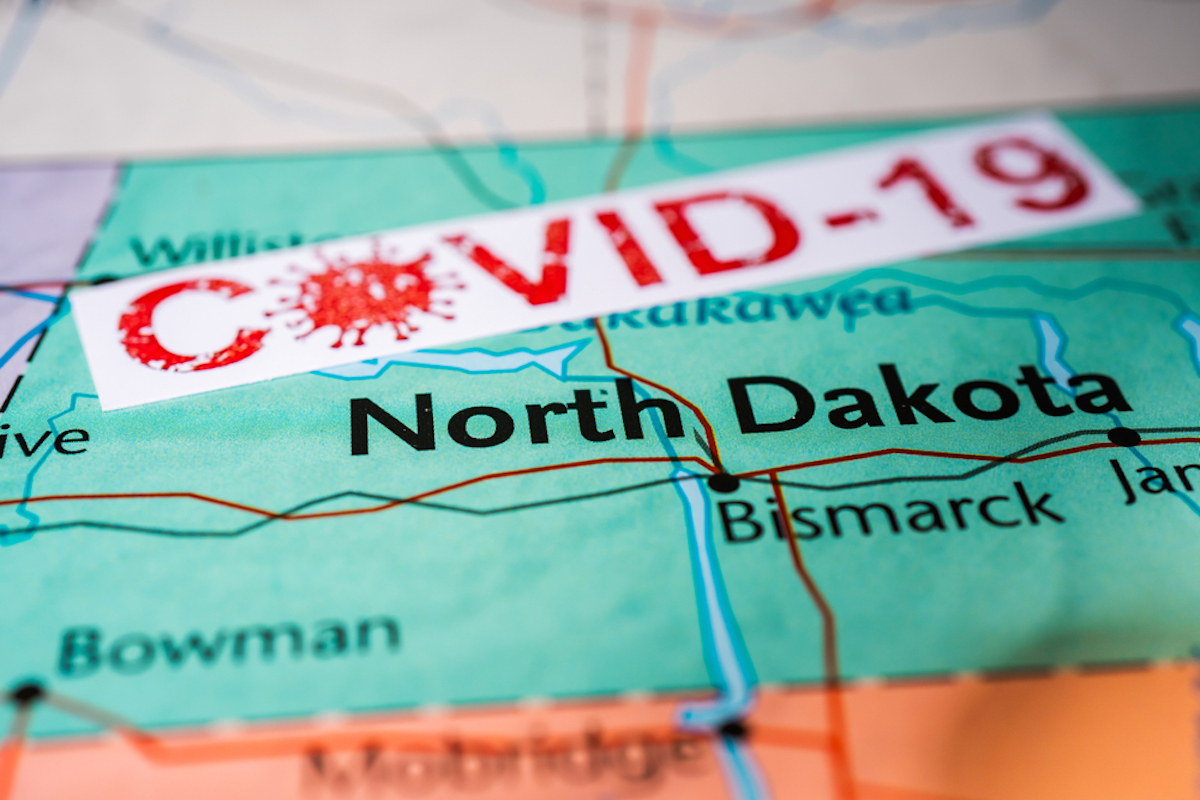 map shows North Dakota with COVID-19 label