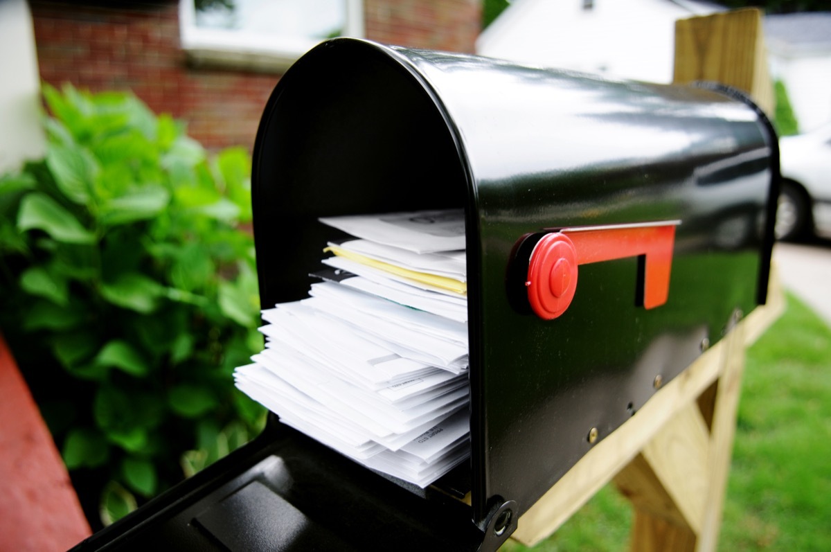 Bills and/or junk mail piled high in a mailbox. Lots of stress in there! Wide-angle.