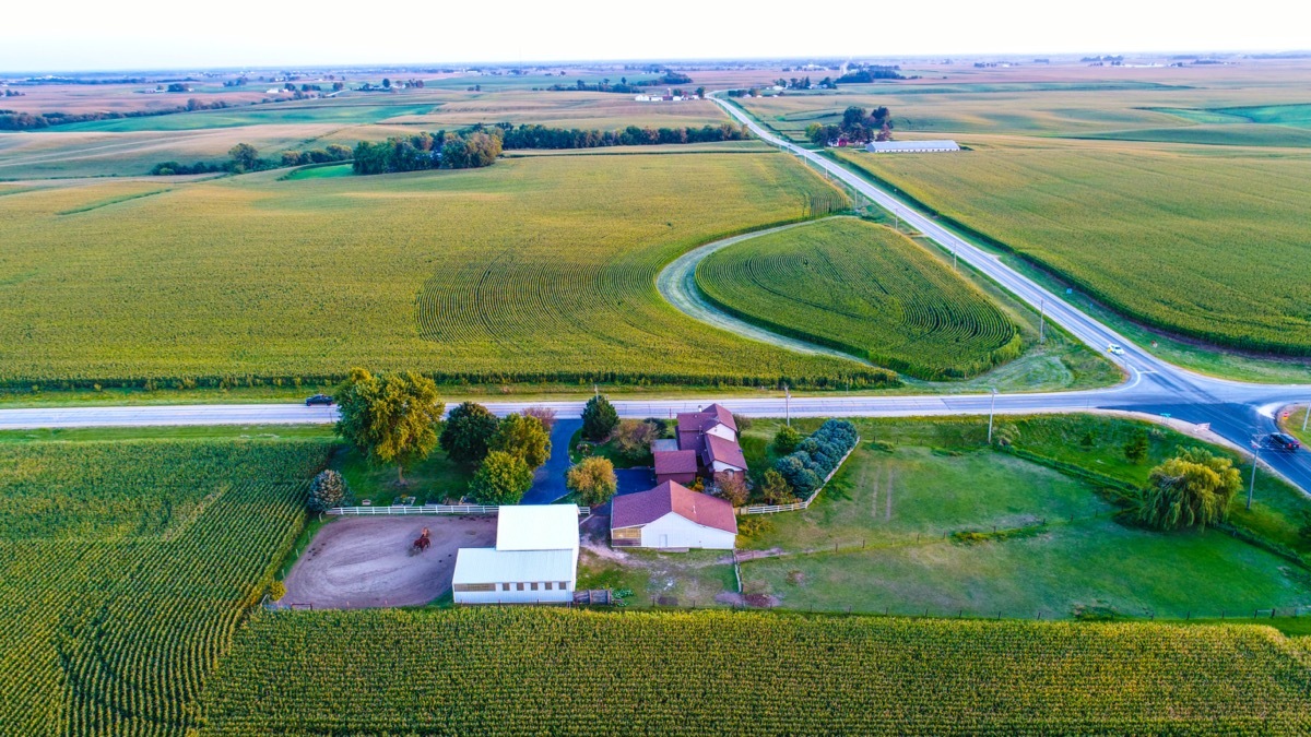 white houses, green land and empty roads, photo taken from above, in Iowa City, Iowa