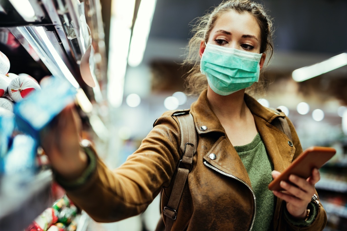 young white woman shopping wearing surgical mask