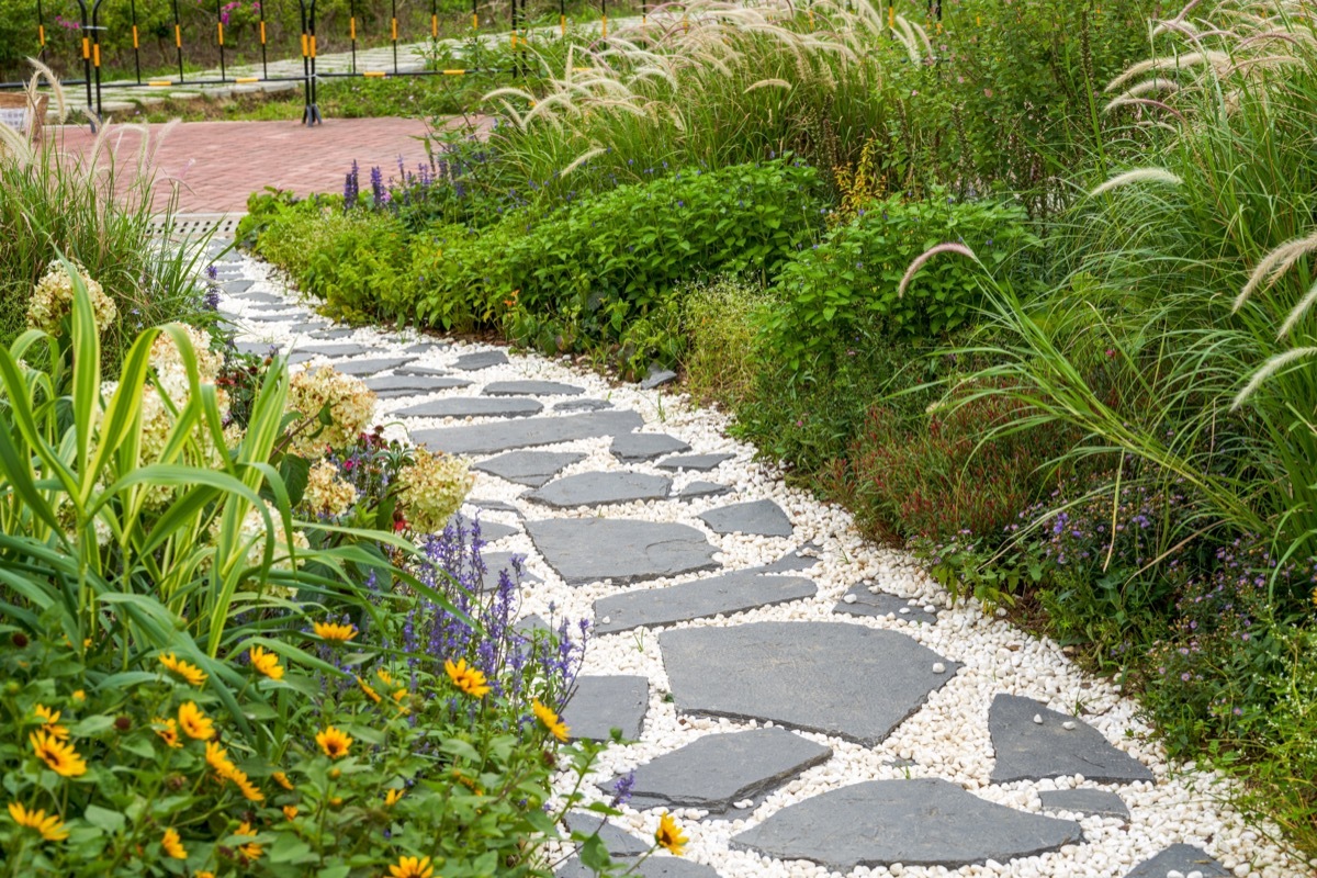 Walking path and zen-like white pagoda gravel landscape in Japanese garden